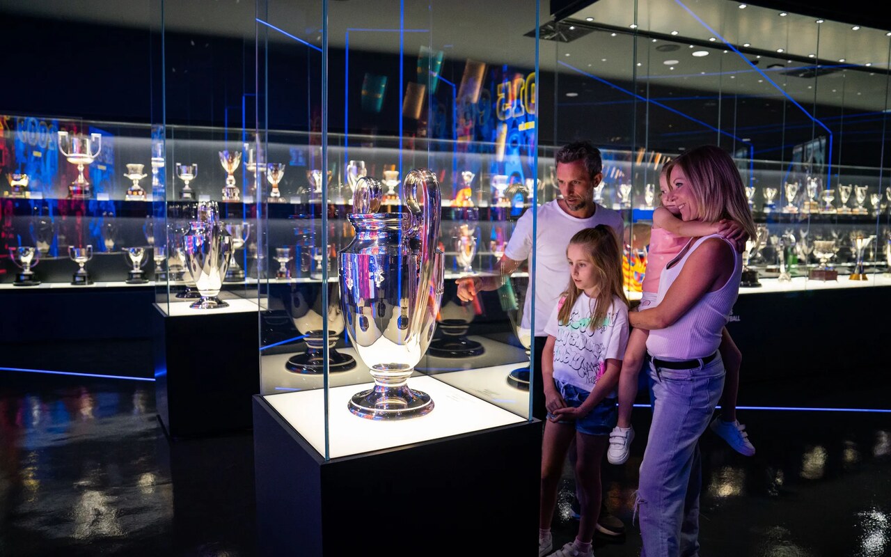 A family looking at the trophy cabinets in the Barça Museum